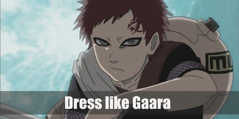 Gaara costume is a red tunic-style coat with one-shoulder grey tactical vest and belts, dark trousers, and sandals. He carries a gourd. His hair is red and has a red tattoo on his forehead.