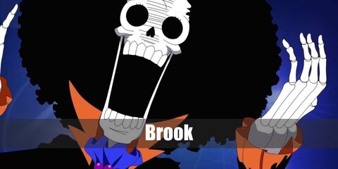 Brooke's One Piece outfit includes a skull mask, orange shirt, black skeletonT-shirt, a blazer, and skinny pants. Accessorized with a necklace, blue scarf, afro wig,  foldable cane, and floral tea cup.