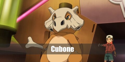  Cubone’s costume is a brown onesie, a Cubone-inspired helmet, and brings along a bone as its club.