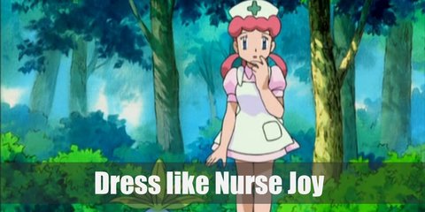 Nurse Joys costume is bubblegum pink hair and fair skin. They wear a white nurse cap, a white vintage apron, a light pink mid dress, and a white pair of Mary Janes.  