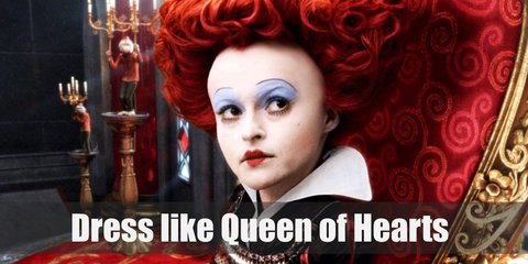The Red Queen of Hearts costume is a gown with gold lined accent and a skirt designed with multiple hearts. She wears a heart-shaped red wig, colored socks, and a gold-toned ankle boots.