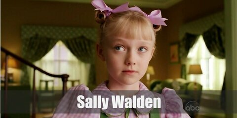 Sally costume is a purple top and wear it with a green dress or pinafore. Then get ribbons to tie the hair in small twin buns.