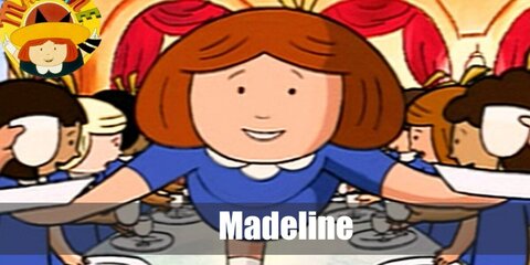 Madeline wears a blue school uniform with a yellow hat. She also wears a pair of white socks and black shoes.