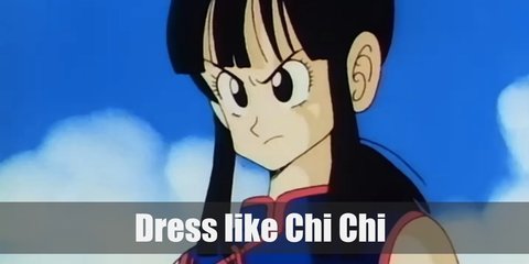 Chi-chi wears a blue cheongsam (Chinese dress) with red belt detail and red trims. She matched her red trimmings with her armband, pants, and shoes. Cop her look with white leg warmers and her hair in a ponytail.