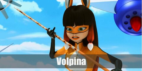  Volpina’s costume is of a white fully bodysuit painted orange and black in some parts, long black gloves, black boots, fox ears and tail.