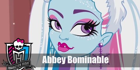Abbey Bominable's costume featues a colorful dress styled with fur trimmings and arm and leg warmers. She has ombre hair and blue skin.