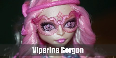  Viperine Gorgon is a girly girl who loves her retro. She wears a floral shift dress, pink boots, and awesome pink snake headband.  