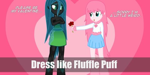 Fluffle Puff costume is wearing a white long-sleeved shirt with furry pink sleeves, a light blue skirt, and furry pink leg warmers.  