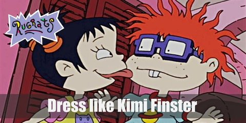 Kimi Finster has blue hair that tied into three buns, and she wears a bright yellow dress with a pink T-shirt underneath it and purple slippers.