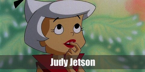 Judy Jetson outfit is an all-pink ensemble with a cropped top, skirt, and tights. She wears flat shoes and has her white hair in a ponytail