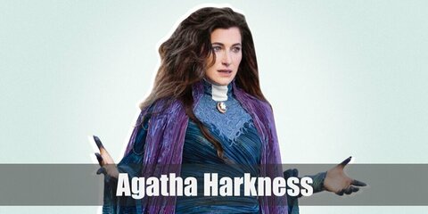 Agatha Harkness cosplay can be recreated with a blue dress with a purple scarf. Then wear a pair of dyed gloves then nail the costume with a wig. 