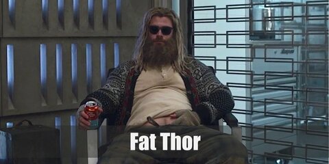  Fat Thor’s costume is a light blue hoodie, a red open cardigan, plaid pajamas, fingerless knit gloves, and a pair of dark sunglasses.