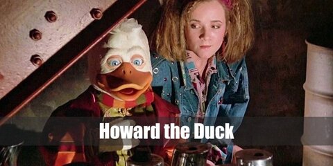  Howard the Duck’s costume is a white dress shirt, a maroon vest, a brown two-piece suit, and a brown fedora.