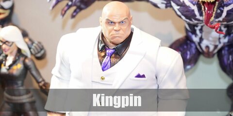 Kingpin’s costume is a white long-sleeved, button-down shirt, a yellow vest, a white suit jacket, purple pants, and a teal cravat. Kingpin is a charismatic crime lord when he wants to be.
