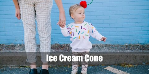  Ice Cream Cone’s costume is an ice cream cone midi summer dress, ice cream cone leggings, flat light brown summer sandals, a cherry-inspired summer beach hat, and red fashion sunglasses.