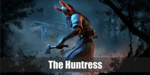 The Huntress’ costume is a white puffed sweater, a red corset, a brown leather harness, denim capri pants, a blue sarong, and a white rabbit face mask.