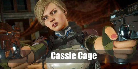Cassie Cage's costume features a navy blue spandex suit styled with multiple harnesses.She carries toy guns,too. She has blonde hair and a pair of boots.