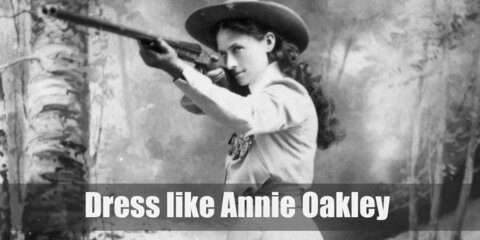 Annie Oakley costume is a western styled shirt with long sleeves, a matching skirt, cowboy boots, and a cowboy hat.