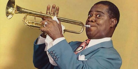 Louis Armstrong wore many fancy and unique suits, and also had the trait of wearing a special red bowtie that stood out from his solid colored suits.