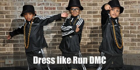 For this outfit, Run DMC are wearing trademark black Adidas tracksuits and sneakers, their gold blings, and bucket hats.