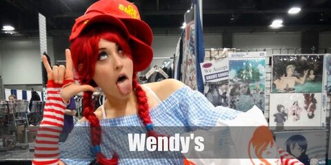  Wendy’s costume is a light blue plaid dress, a white waist apron, white sneakers, red and white-striped fingerless gloves, and striped socks. Complete the look with a red wig done in pigtails.