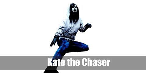  Kate the Chaser’s costume is a printed red t-shirt, distressed and ripped black jeans, black and white sneakers, and a hooded white running jacket.