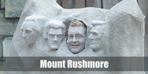 Mount Rushmore’s costume is a grey shirt, grey pants, grey sneakers, wooden dowels, wire, papier mache, paint, and a few costume accessories.