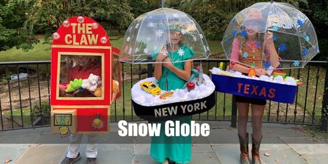 The Snow Globe costume can be done by wearing a cage petticoat styled as the base of the globe with a fluffy blanket. Carry a clear umbrella, too.