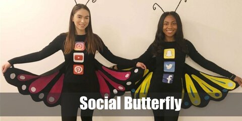  Social Butterfly’s costume is a long-sleeved black shirt and black leggings with social media app stickers all over them, colorful sneakers, a butterfly antenna headband, and butterfly wings.
