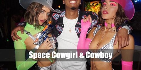 The Space Cowgirl look can be recreated by wearing a silver top styled with a neon pink hat, bandana, and boots. The Space Cowboy look features a space suit with a neon hat and pair of boots, too.