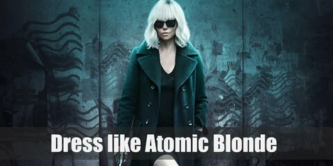 Lorraine Broughton aka Atomic Blonde wears a black trench coat on top of a simple black dress, a pair of black stockings, black thigh high boots, black sunglasses, and a gray scarf.