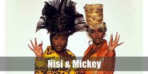 Nisi's orange fit features a top and tight pants, clear heels, and a blonde updo. Mickey's costume has a leopard-print top and bottom styled with dark hair, yellow heels, and beads on her hair. 