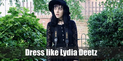 Lydia Deetz costume is mainly lots of black dresses, black tights, black lace accessories, and extremely large black sun hats.