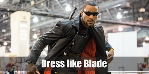 Blade costume is a dark armor vest with black tactical pants, leather gloves and shoes, dark sunglasses, and a leather long coat.