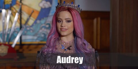 Audrey’s costume is a pink and black outfit with swirls, pink ankle boots, mixed pink and light blue hair, black nail polish, and a princess crown '