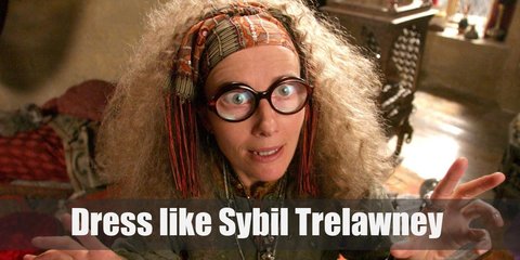 Professor Trelawney costume is patchwork clothes in earthy tones and she is very partial to shawls. For most of the movies, she wears a tunic, maxi skirt, bandanna headband, and big round glasses. 