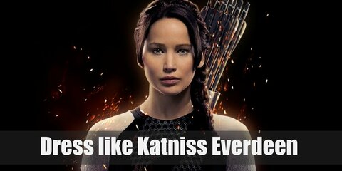 Katniss Everdeen costume is wearing a black shirt, olive green pants, a black thermal jacket, and brown boots. She’s also holding her weapon of choice: a bow and a quiver of arrows.