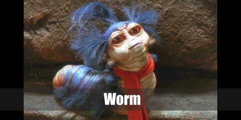 The Worm’s costume features a blue wig and puffer vest with blue fringe.