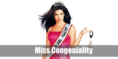  Miss Congeniality’s costume is a high-slit pink cocktail dress, high heeled laced-up black ankle boots, a gun in a leg holster, and a crystal tiara.