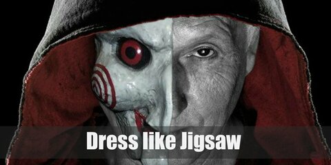 John Kramer or Jigsaw wears a long black robe with red inner hood, a gray T-shirt, black pants, black gloves, and black boots.