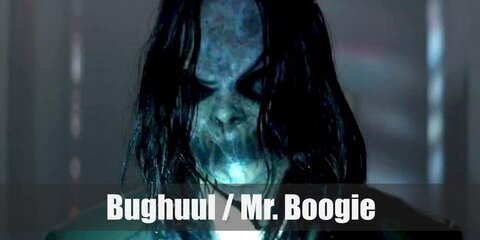 Bughuul or Mr. Boogie wears a white shirt under his long coat. He has his mouth shut together and has long hair, dark eyes, and monster hands.