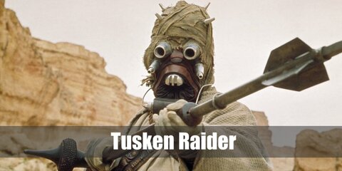 The Tusken Raider can be recreated with a mask made from a balaclava or ski mask styled with a bottle cap near the mouth and a pair of round goggles. Then, wear a sand-colored robe styled with a harness. Carry a spear to complete the outfit.