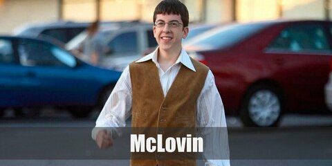 Mclovin's costume features a striped button-down shirt under a brown vest. He wears dark pants and a pair of eyeglasses.