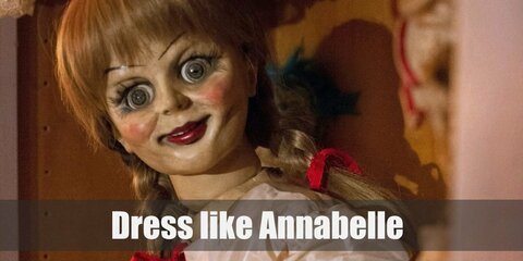 Annabelle costume is a white tea party styled gown with a red belt at the mid waist and a pair of white shoes. While the Nun is wearing a typical Catholic nun outfit with black cloak and all.