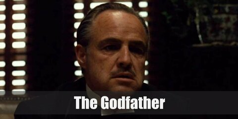 The Godfather's costume features formal clothes as well as a bowtie and a rose lapel pin. Complete the costume with gray streaks on the hair and a fake mustache.