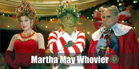  Martha May Whovier’s costume is a red tube top, a green maxi skirt, red long velvet gloves, and red and gold jewelry.