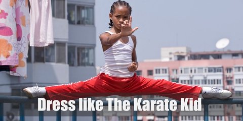 Jaden Smith's Karate Kid reboot costume a white sleeveless top, red karate pants, black socks, and black shoes. His hair is in cornrows, too.
