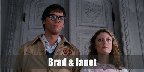 Janet's costume features a pink dress styled with a white cardigan, pair of shoes, and bag. Meanwhile, Brad's costume features layers of shirt, vest, and jacket paired with grey pants!