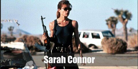  Sarah Connor’s costume is a black tank top, black cargo pants, black combat boots, black harness with tactical belt, black cap, and dark sunglasses.