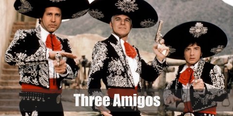 The Three Amigos costume include a mariachi-inspired ruffled top, jacket, and pants with a red bow and sash. They also wear a sombrero or a wide hat. 